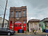 The little house to the right of the firehouse.