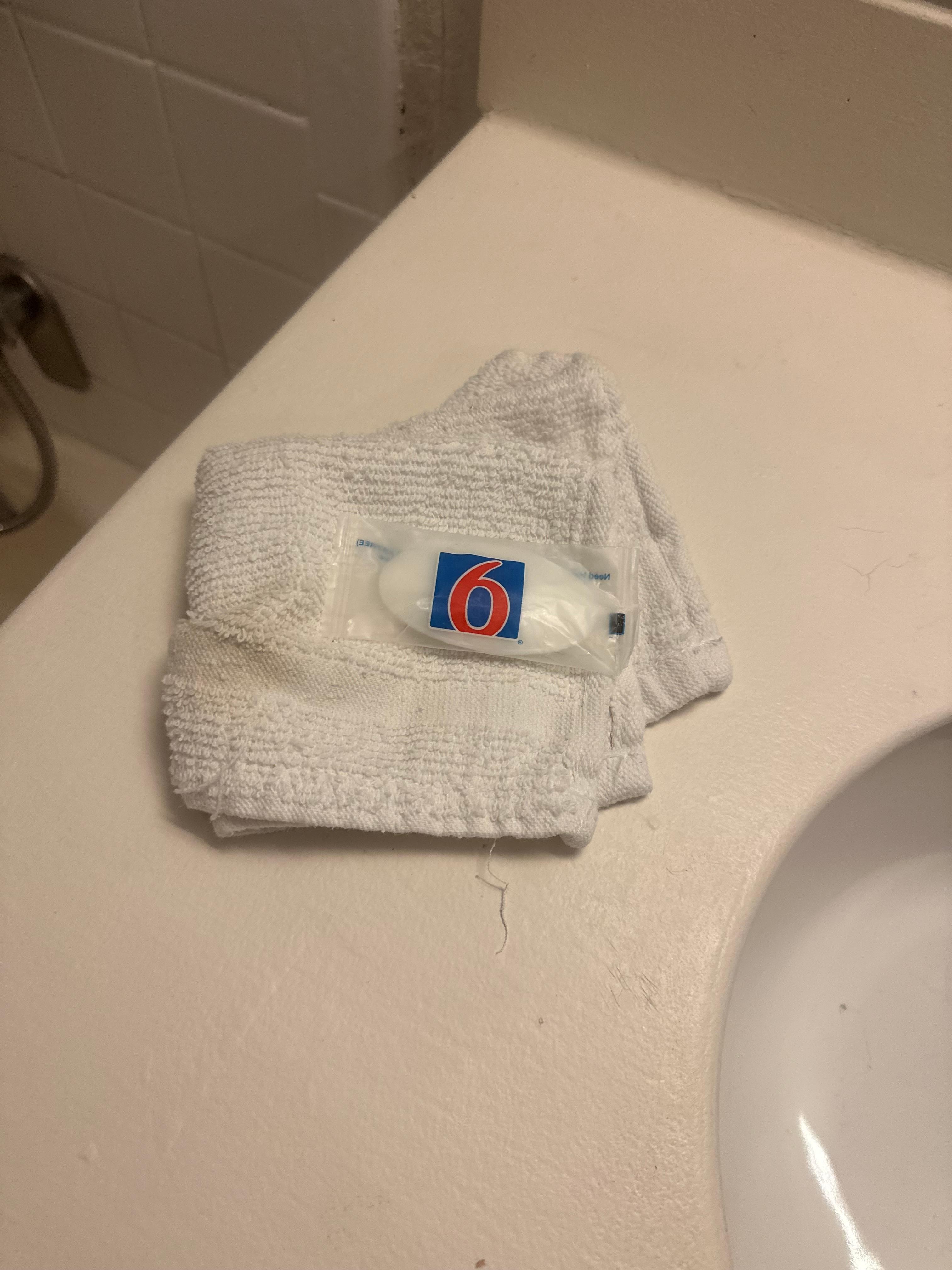 One hand towel that is clearly old and unclean.
