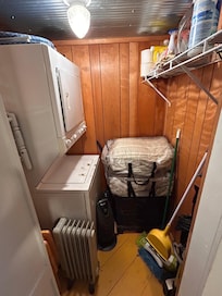Storage closet with washer and dryer and cleaning supplies