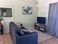 Living area next to dining area. Another sitting area to the right of the living area.