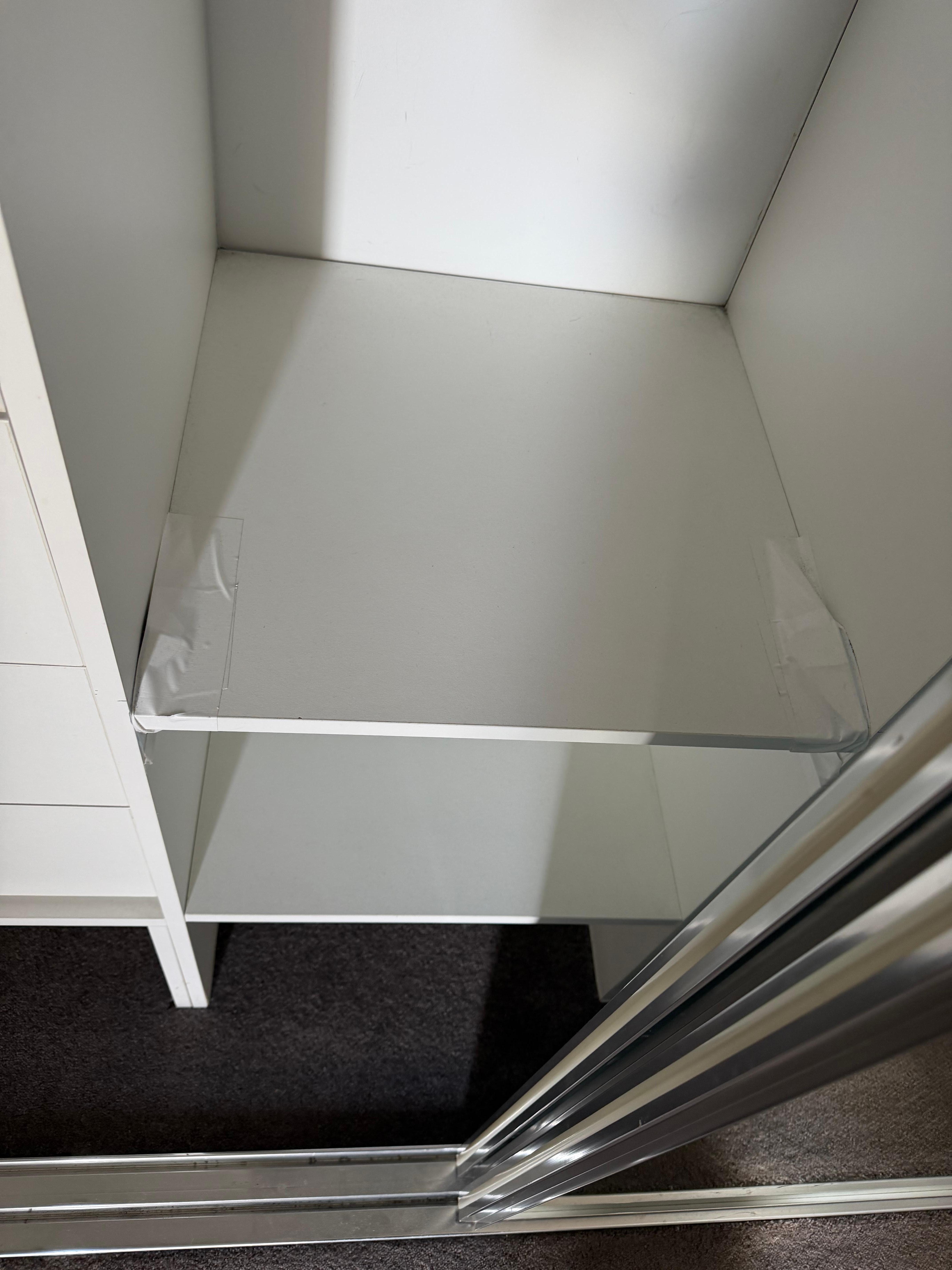 Shelves held together by tape 