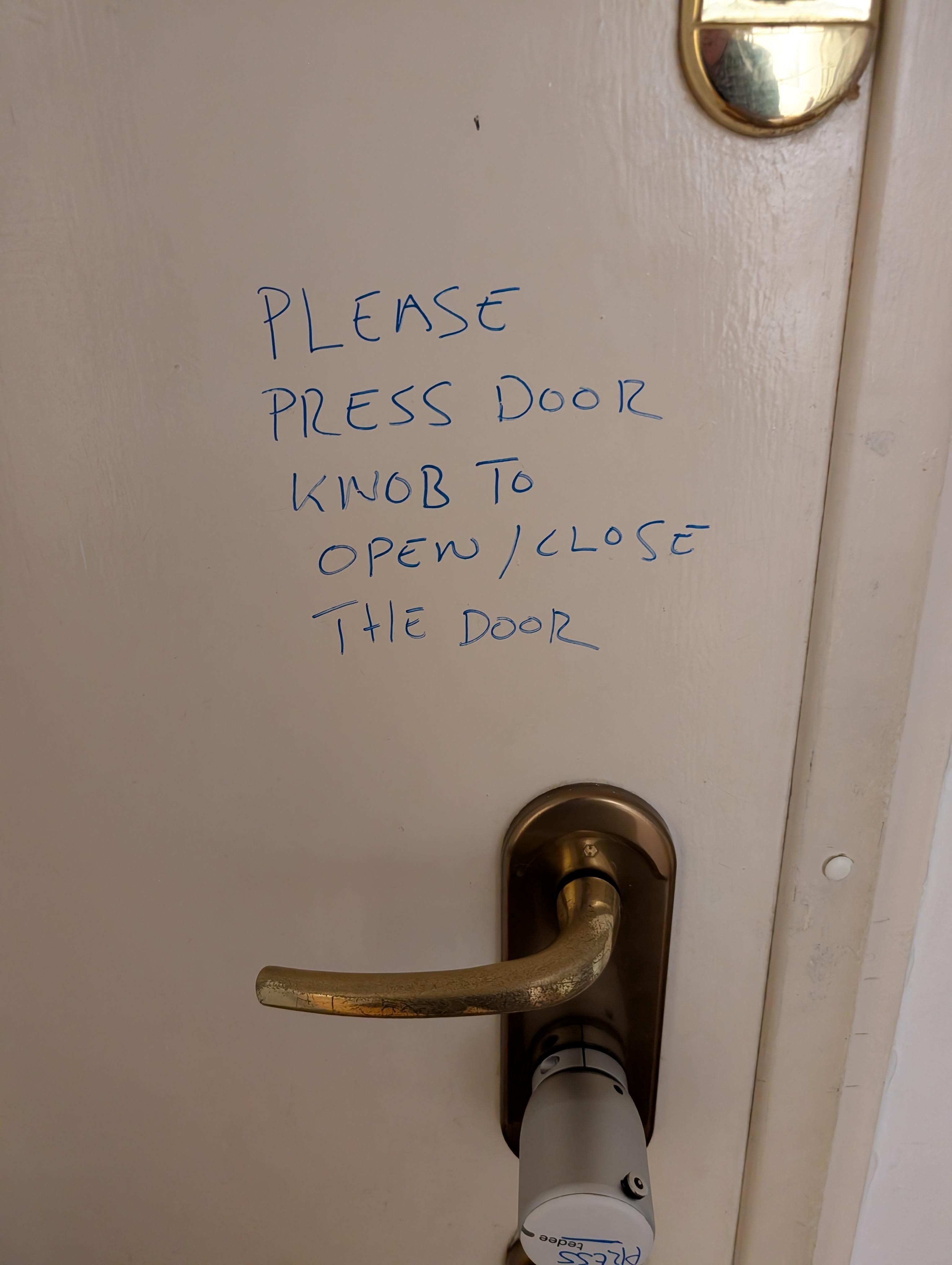 With luck, door will open when you press the white knob but it was unreliable. Note the care taken in scribbling the instructions! 