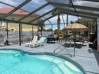Enjoying the pool while playing ping pong
