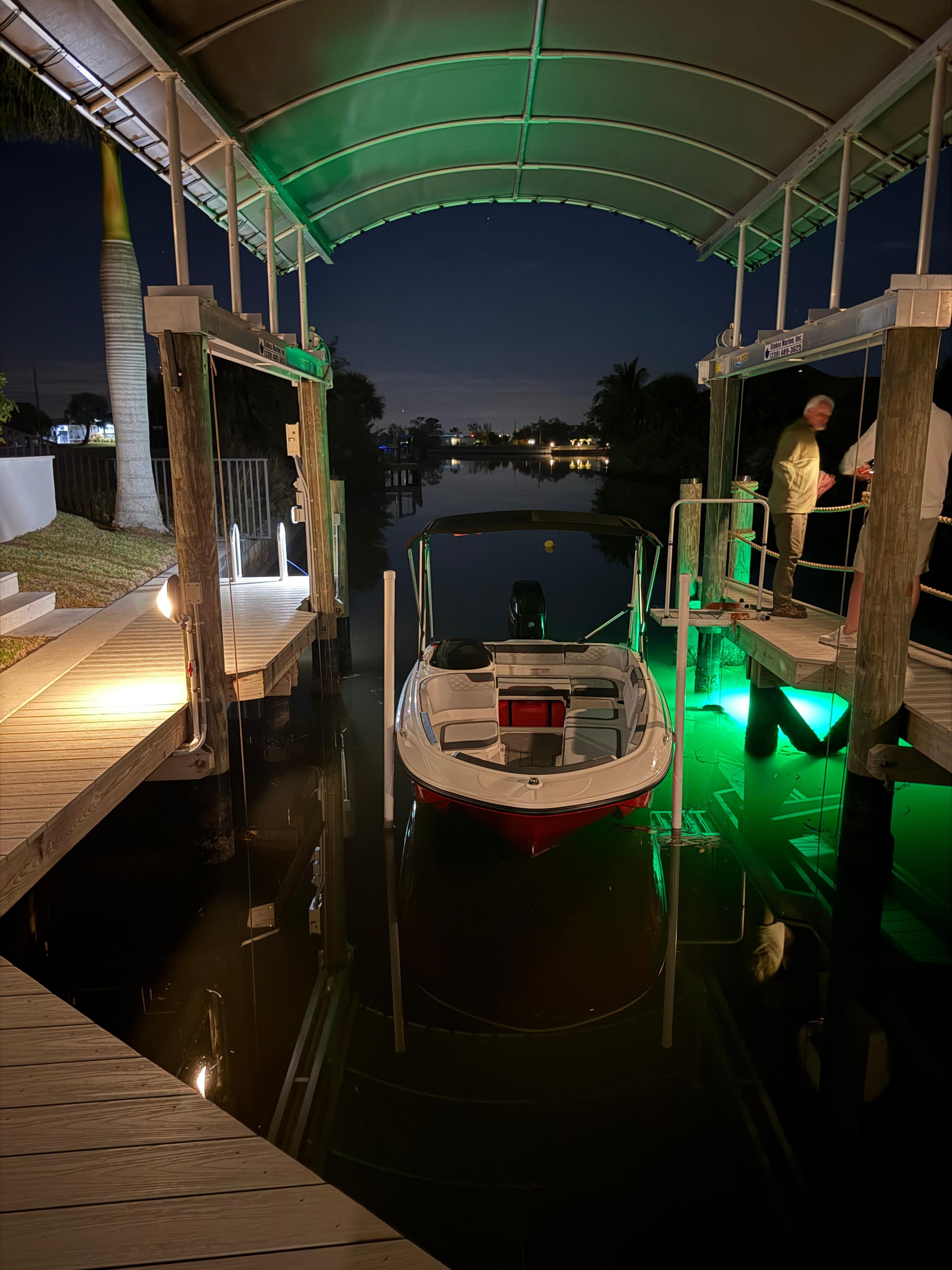 Boat Dock at night where you can see fish.  