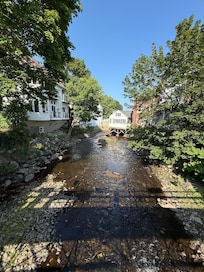 Downstream from the bridge. For reference hotel is behind.