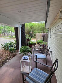 Little garden area with bird feeders next to the porch chairs