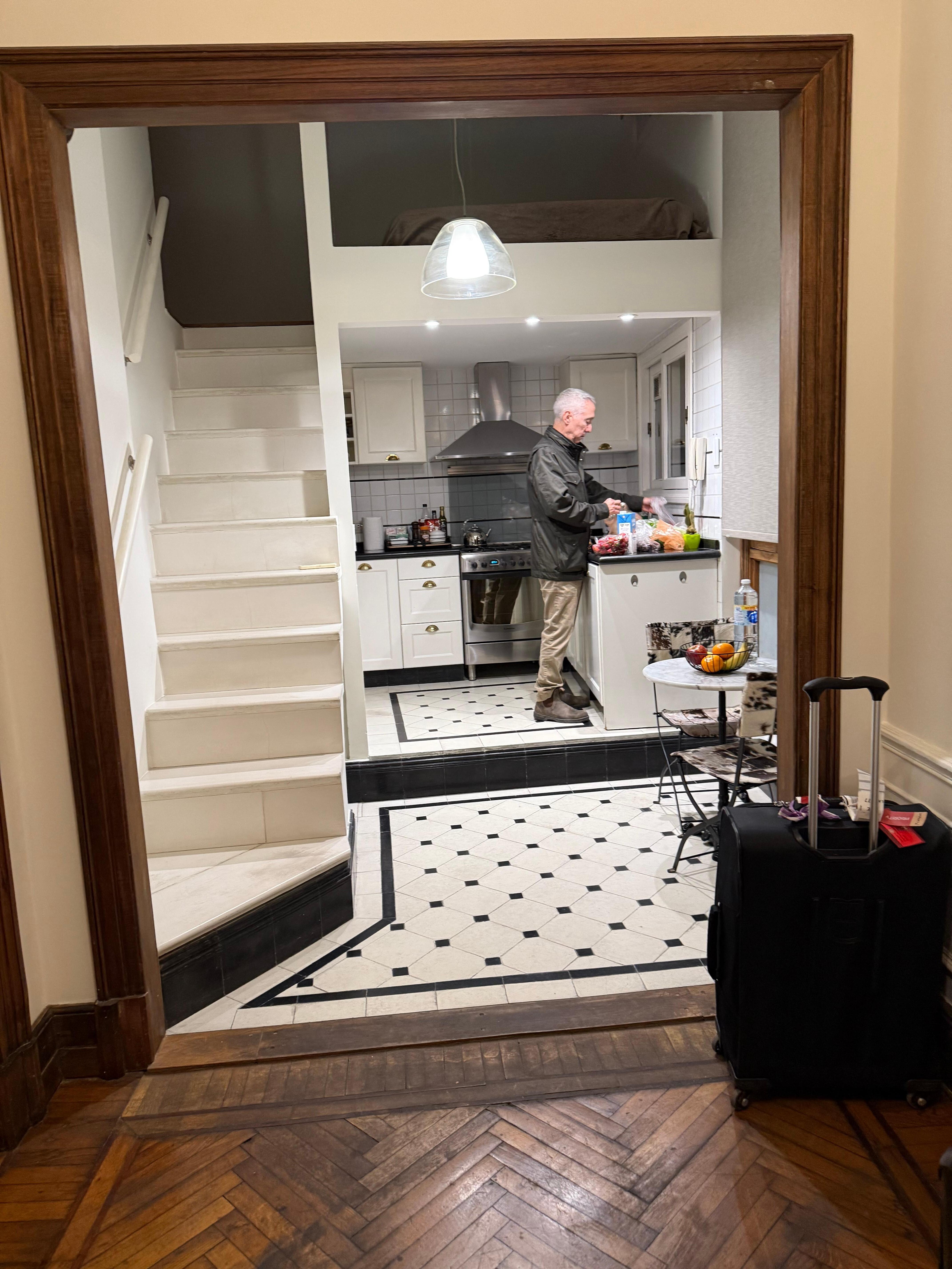 Access to the loft bedroom is the open stairs at the left