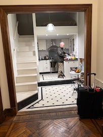 Access to the loft bedroom is the open stairs at the left