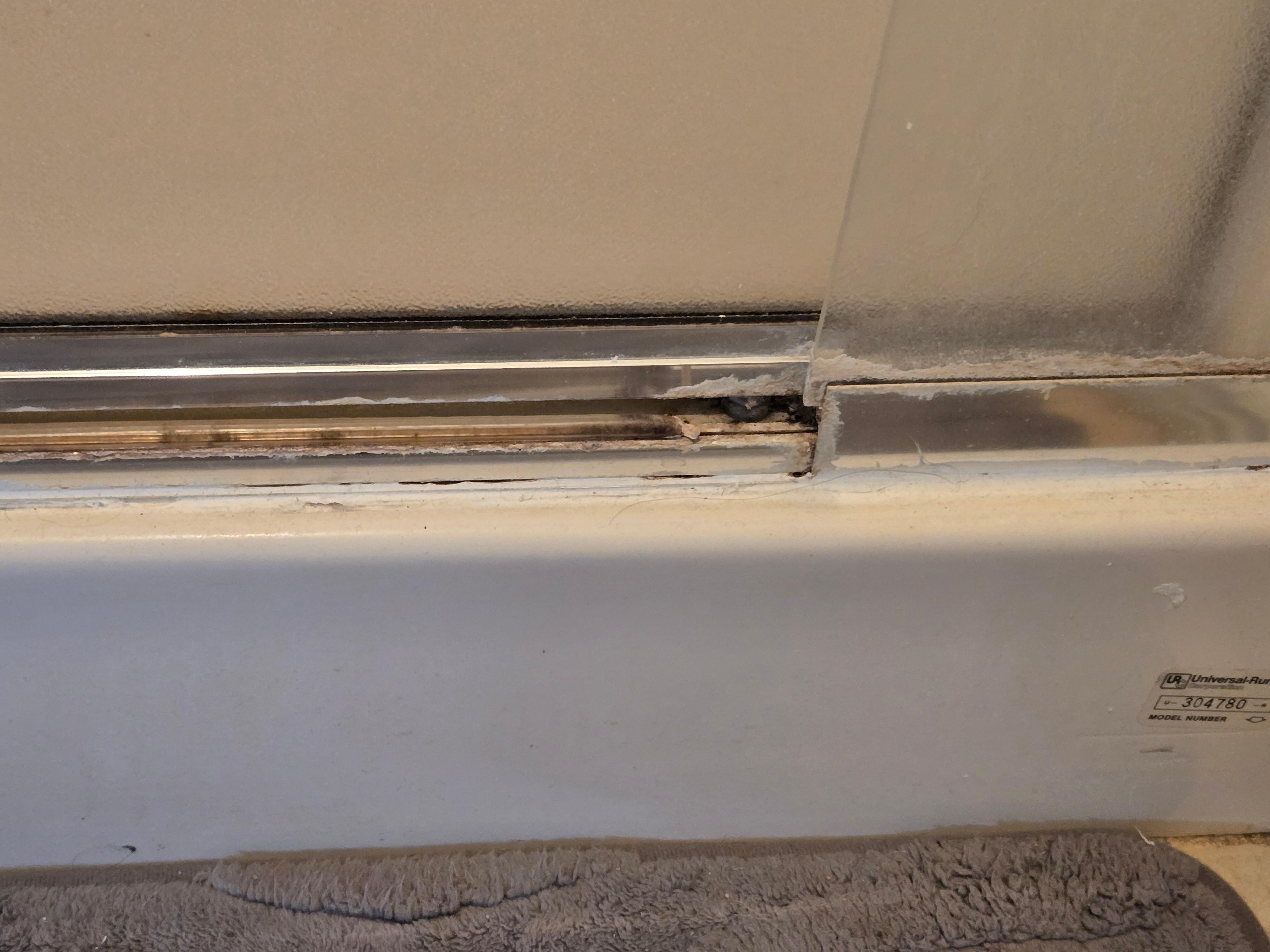 mold at base of master bedroom shower  
