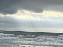 Sun through clouds from the beach