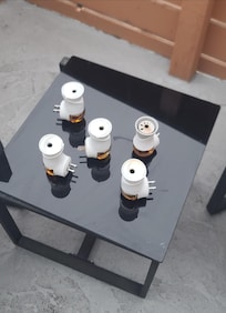 Five plugin oil diffusers set outside.