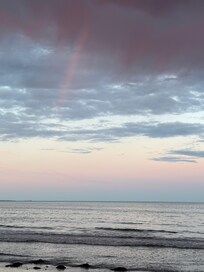 Rainbow over the ocean near the house.