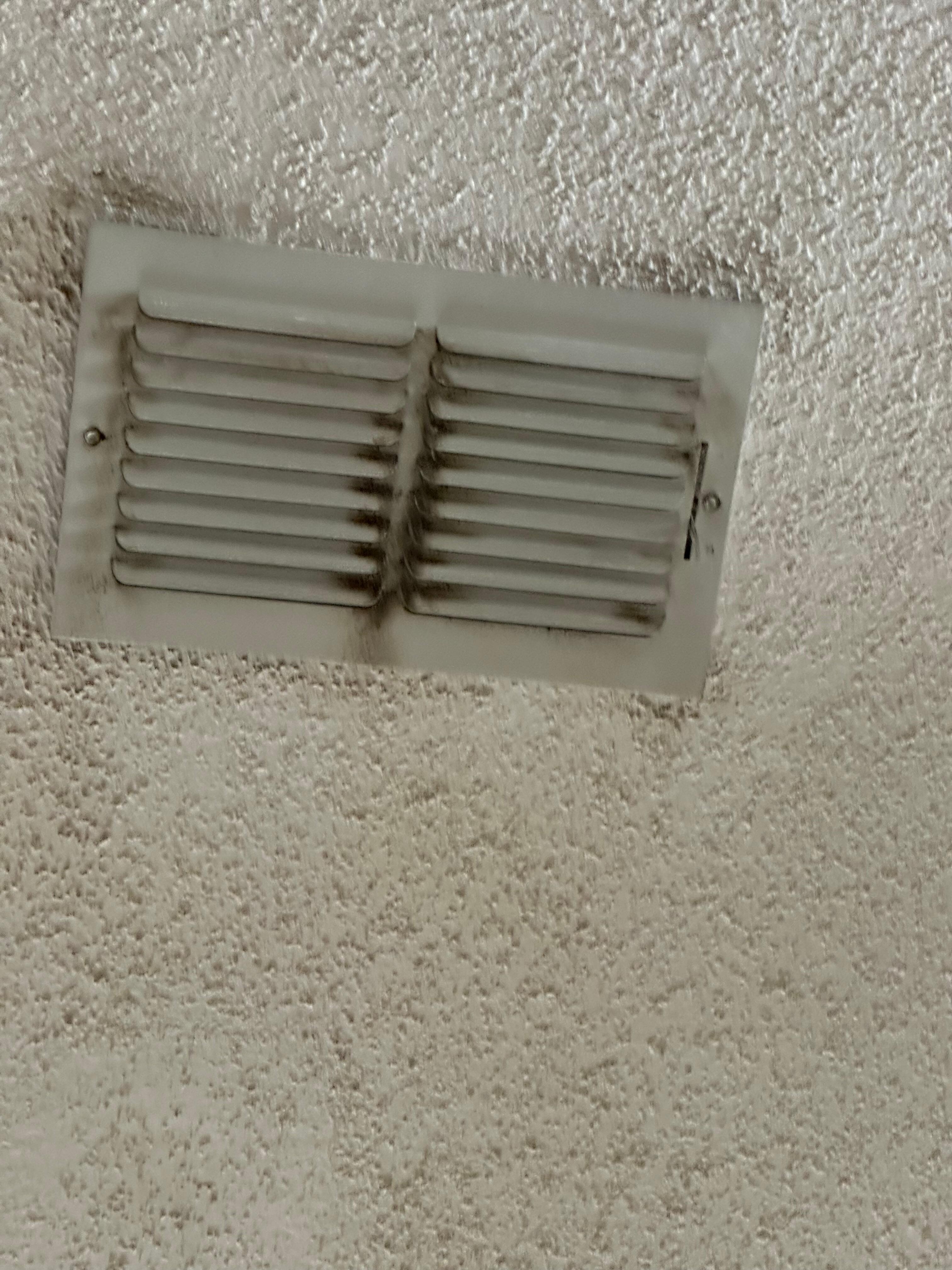 Dirt on ceiling around ventd