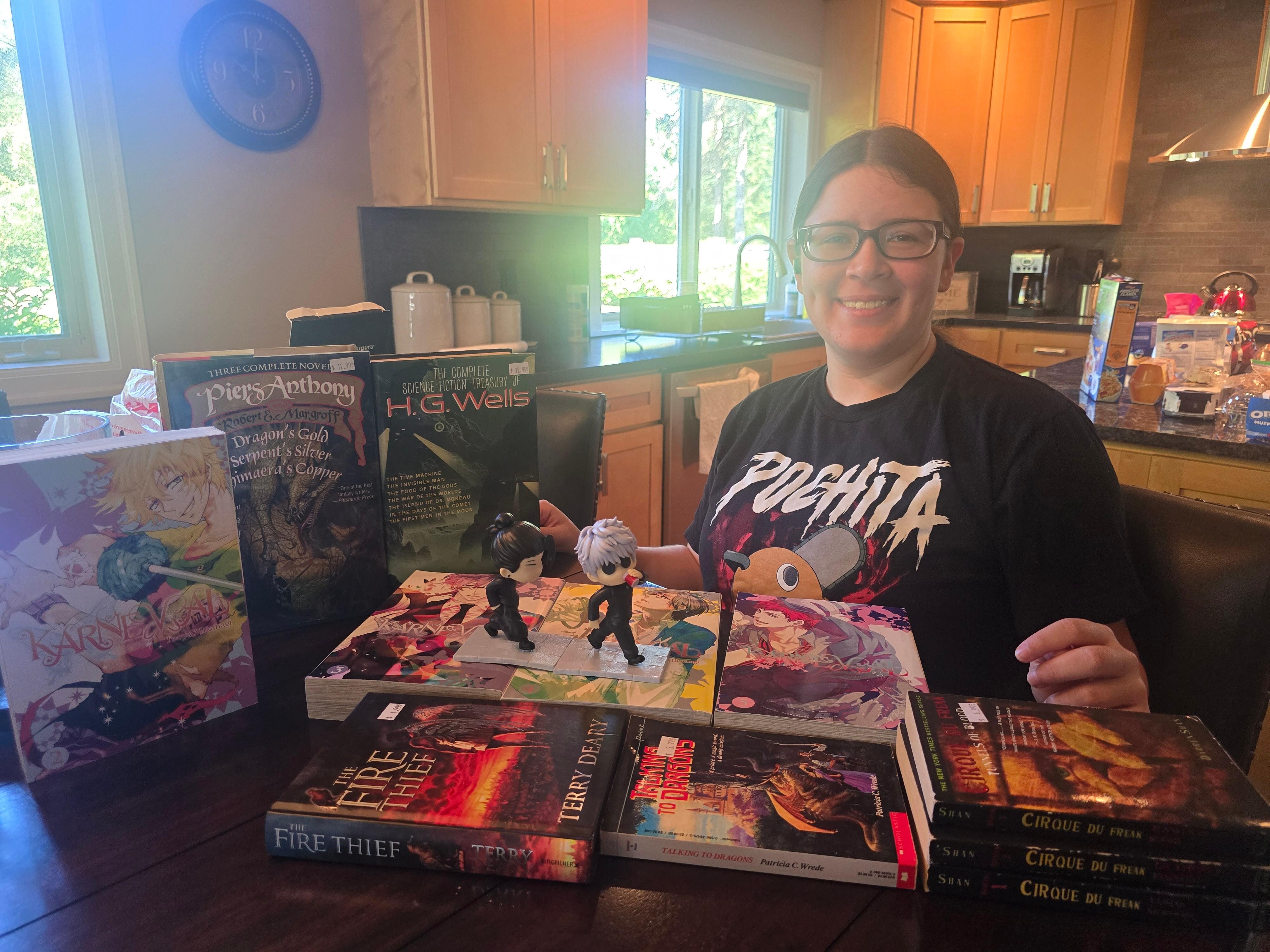 Our oldest sitting at the dining table with the kitchen in the background. We randomly went to the Kent Valley Cornicopia Festival and these are some items she got from the festival and the local bookstore there.