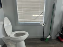 As you walk up the stairs to get into the house, there are blinds next to this toilet which you can see people using from outside the home due to broken blinds.
