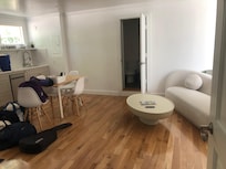 After just carrying in belongings. View from bedroom doorway to kitchen, bathroom and living area.
