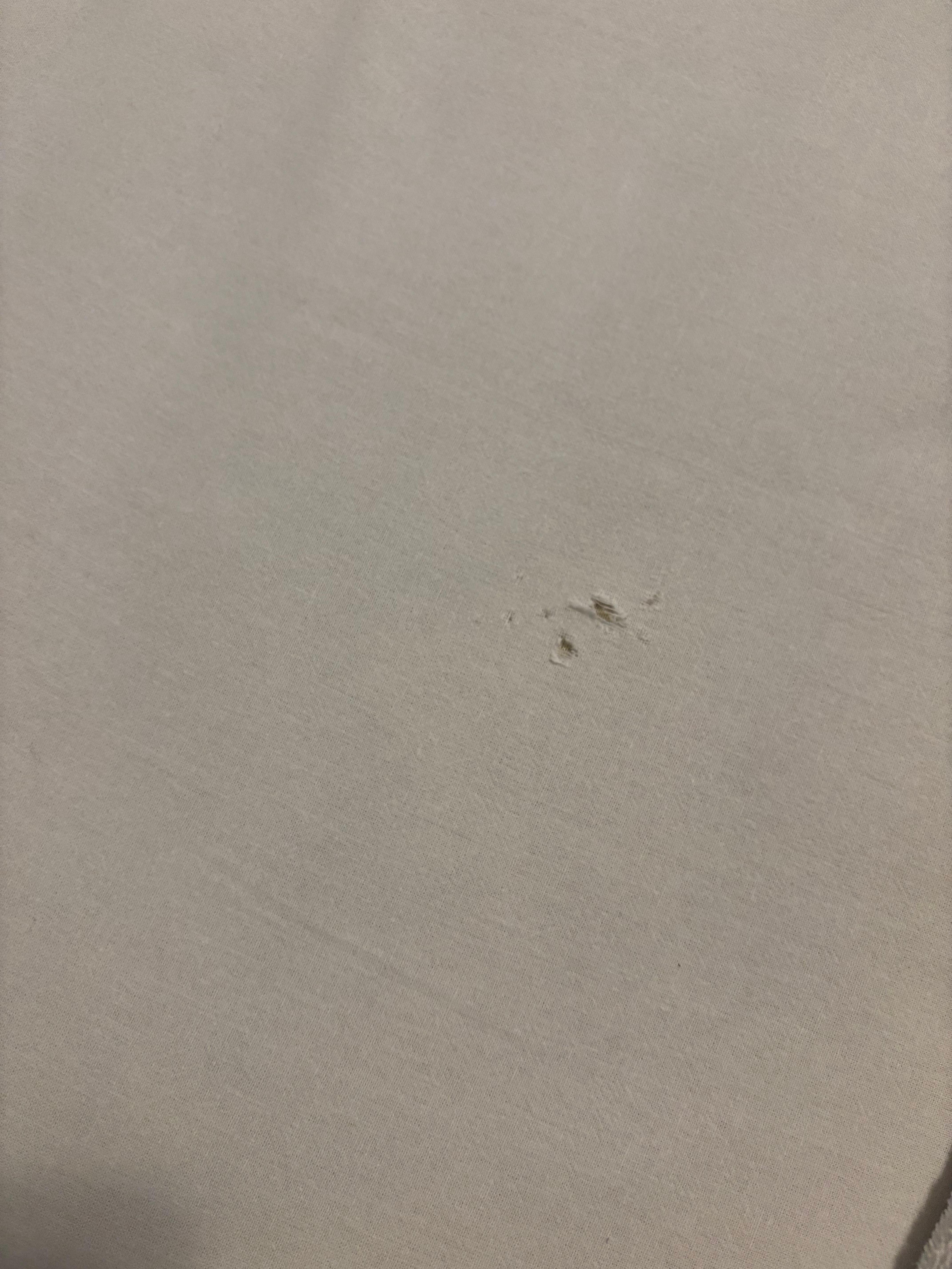 Worn out bed sheet with hole 