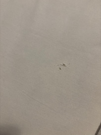 Worn out bed sheet with hole