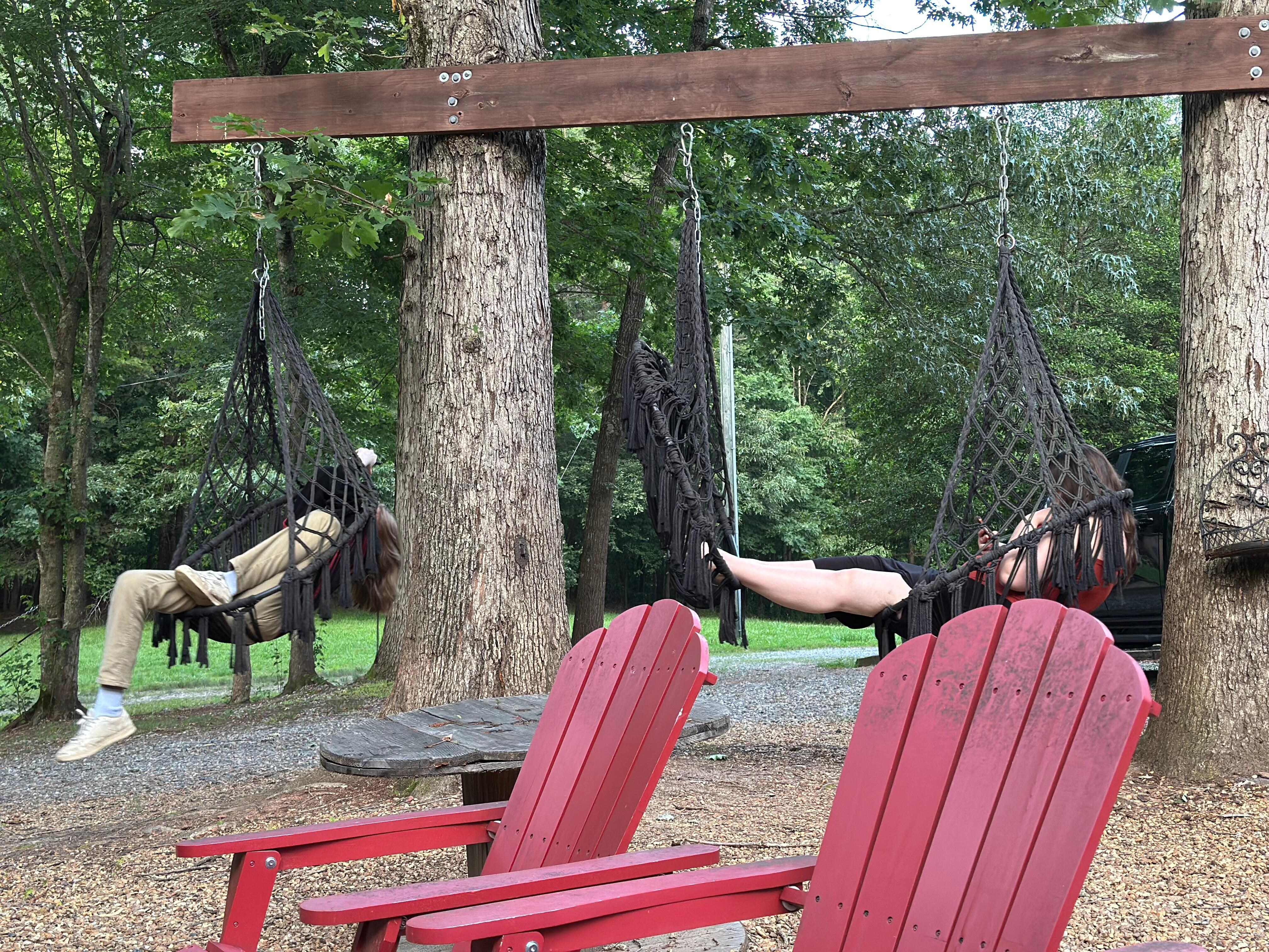 Two of the kids are chilling in the hammock chairs