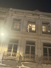 View looking up at apartment windows at night.