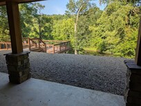 View from the back patio toward the deck and the river. Notice the drop-off.