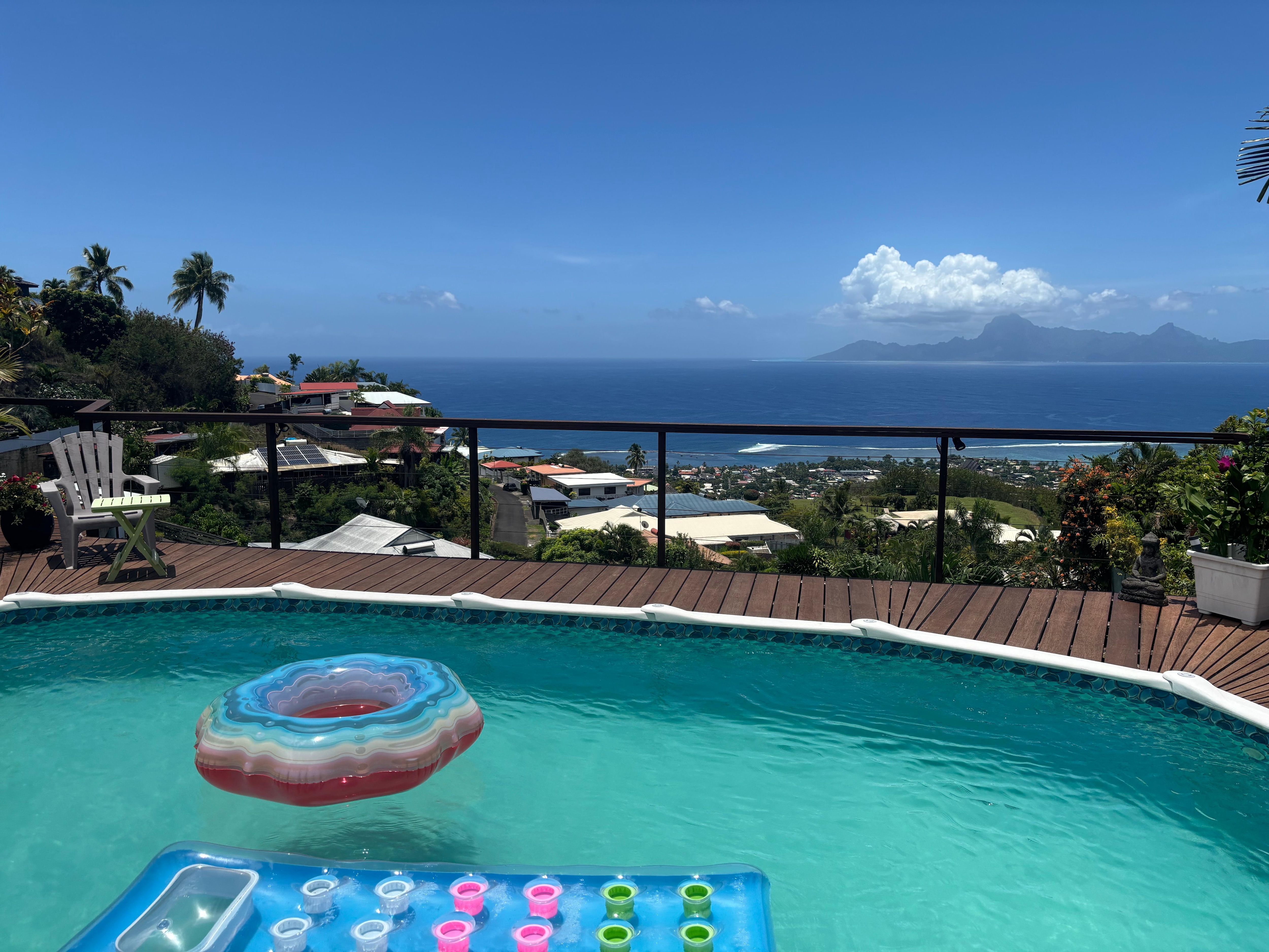 Lovely pool on a patio with a beautiful view of the Punavai Nui mountain and the Pacific Ocean in the distance 