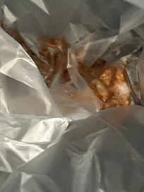 waste under the trash bag in bathroom trashcan.