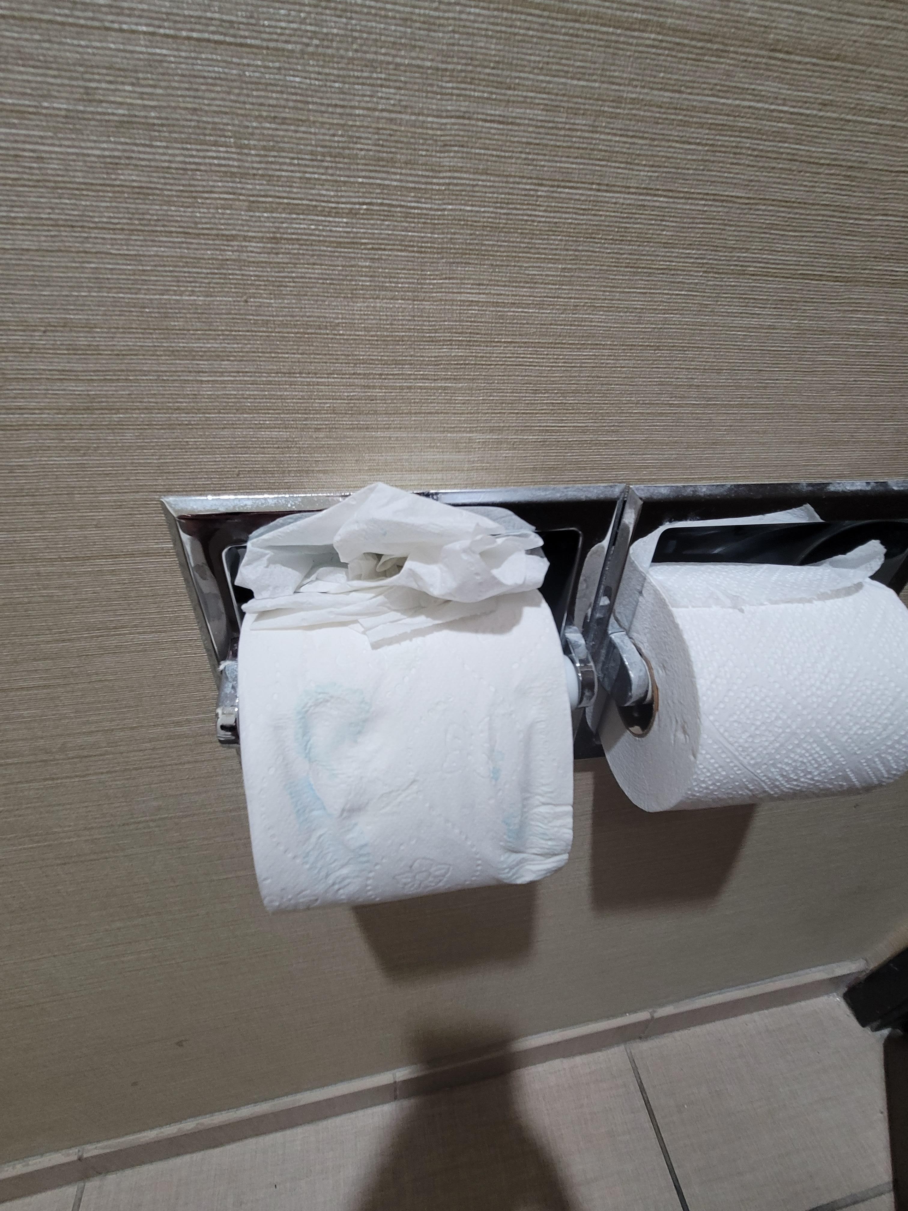 Toilet paper roll had been wet and stained with something blue?