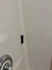 hole in shower wall repaired with duct tape