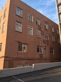 The hostel building right to it and the parking lot