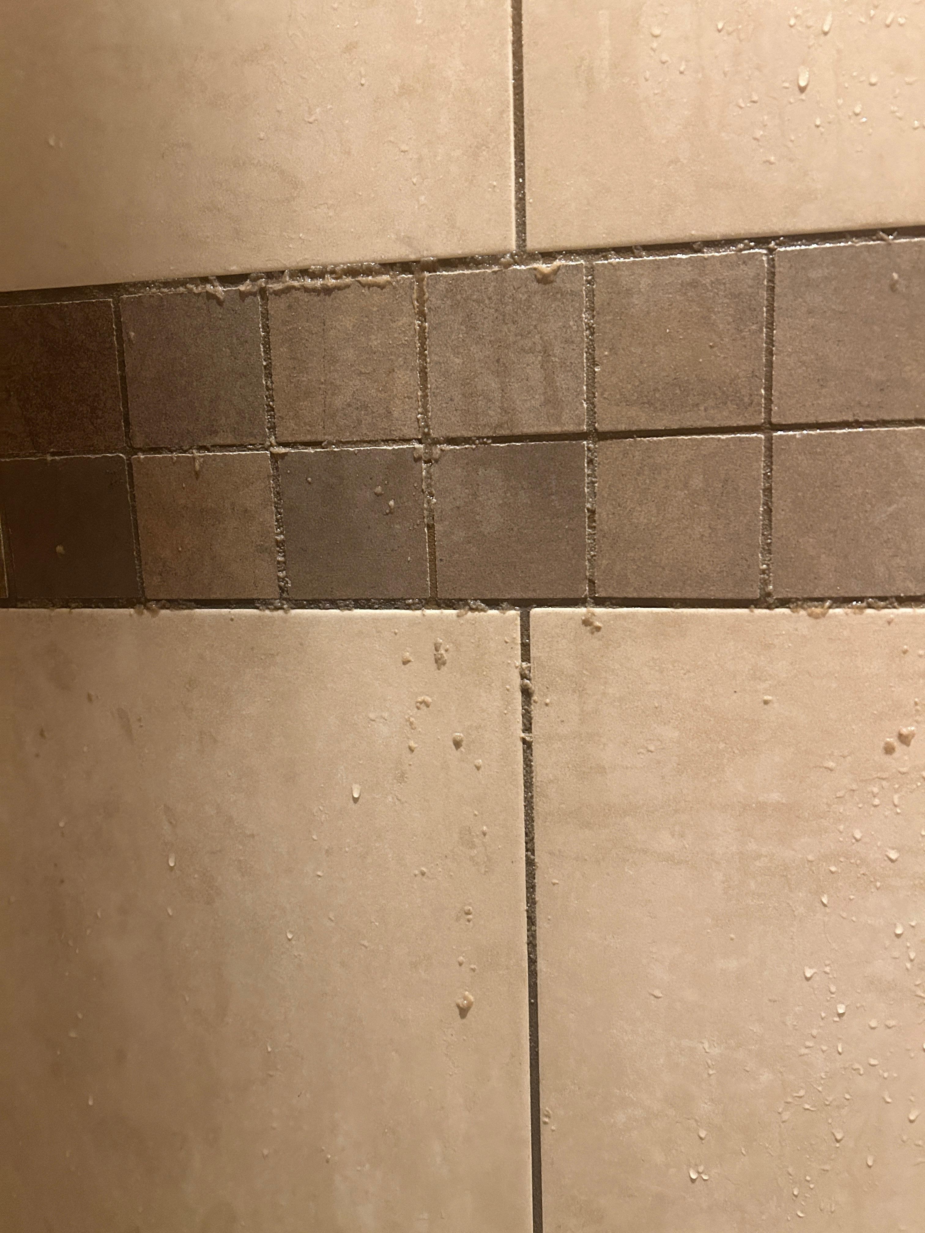 Shampoo or conditioner coming out of the grout after our first shower 