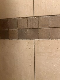Shampoo or conditioner coming out of the grout after our first shower