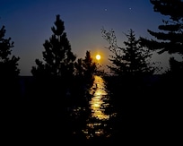 The moon is rising over Lake Superior.