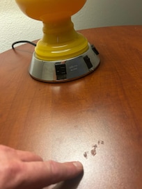 Dirty glop on table with 1980s lamp.