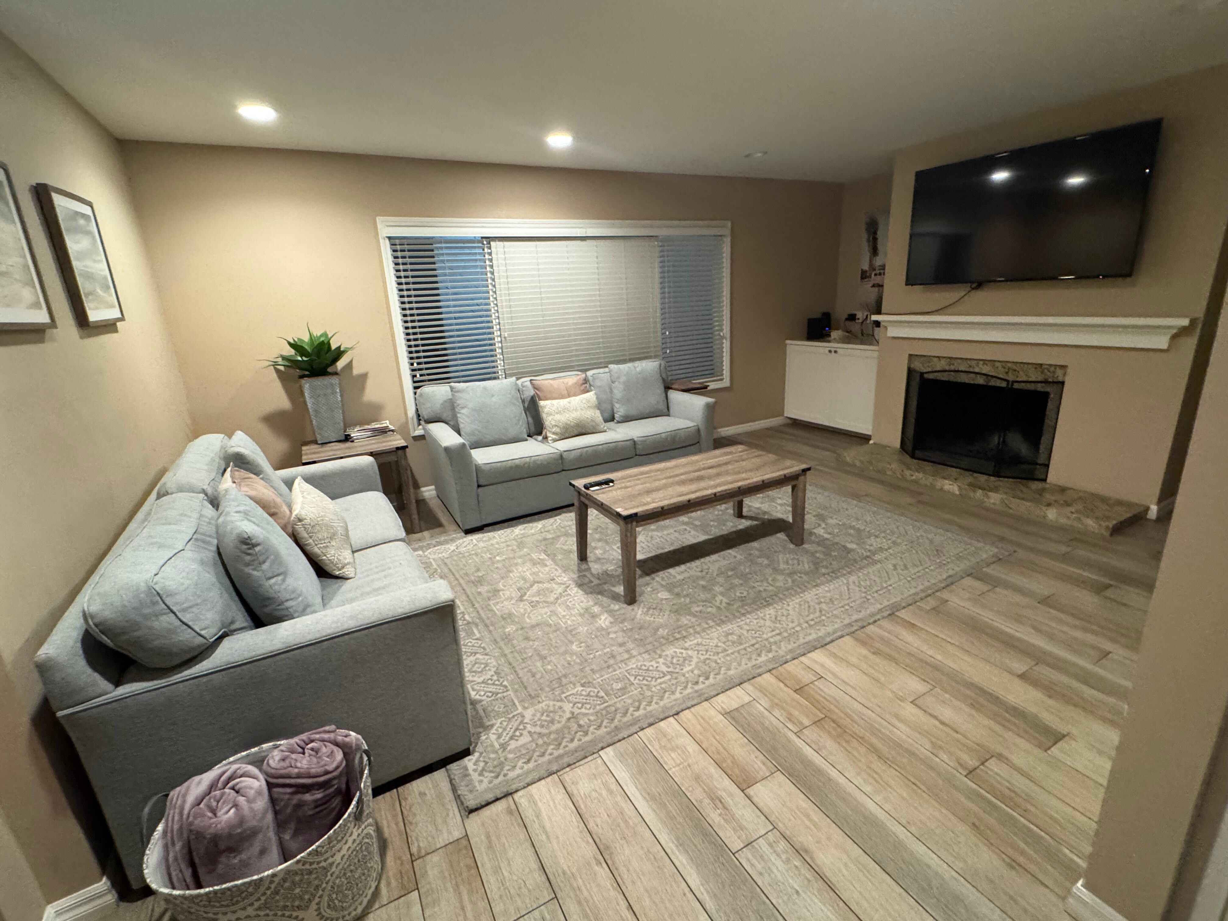 Spacious living room, comfortable sofas, large T.V., beautiful flooring and lovely beach colors/decor!