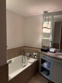 Deep soaking tub and across is a separate rainfall shower