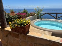The hot tub and view... it was hot during our stay so we used it as a plunge pool!