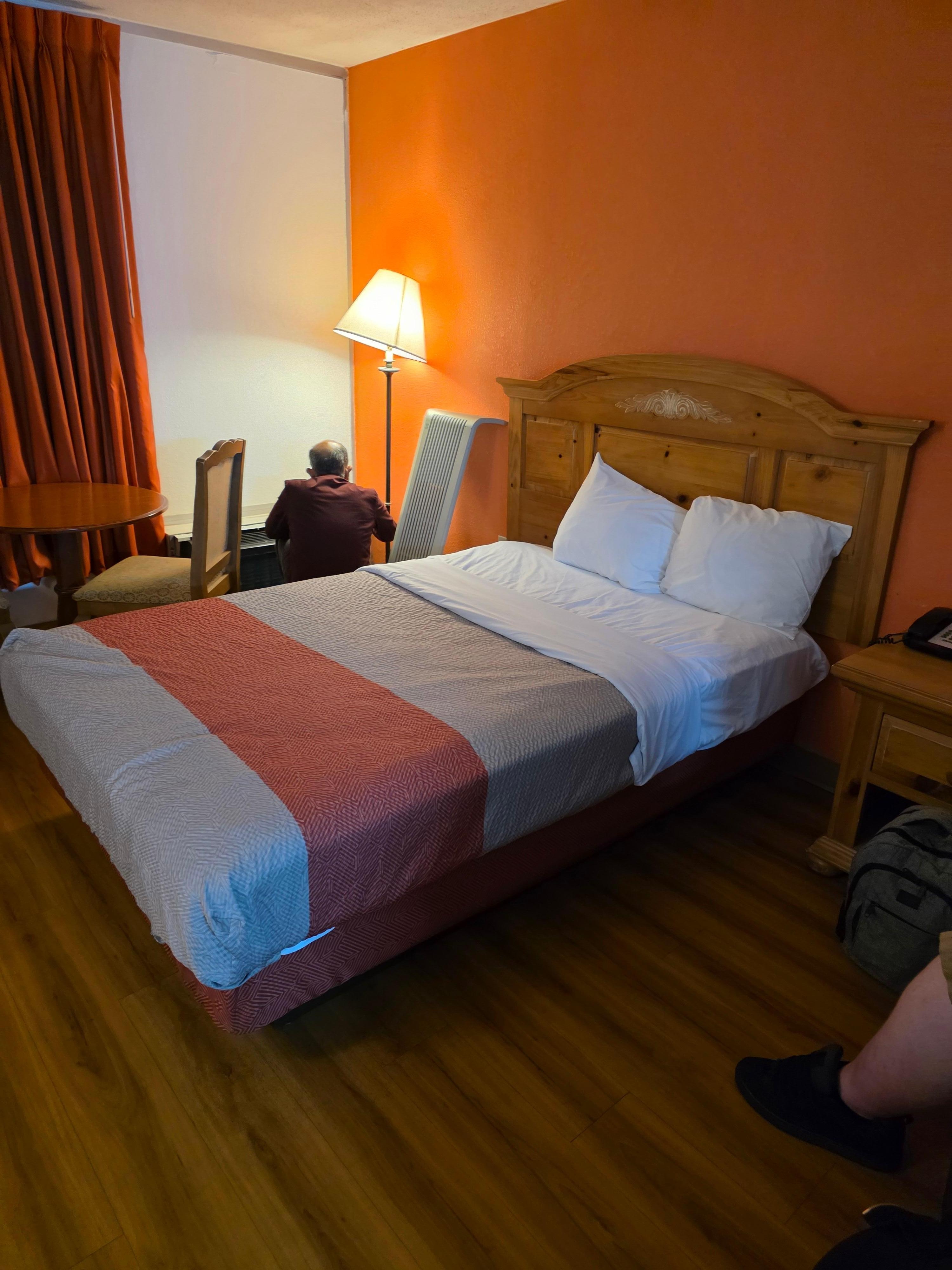 Maintenance man fixing the heating in the first room they put us in