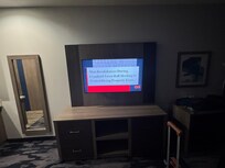 Photo shows main room with large sized TV.