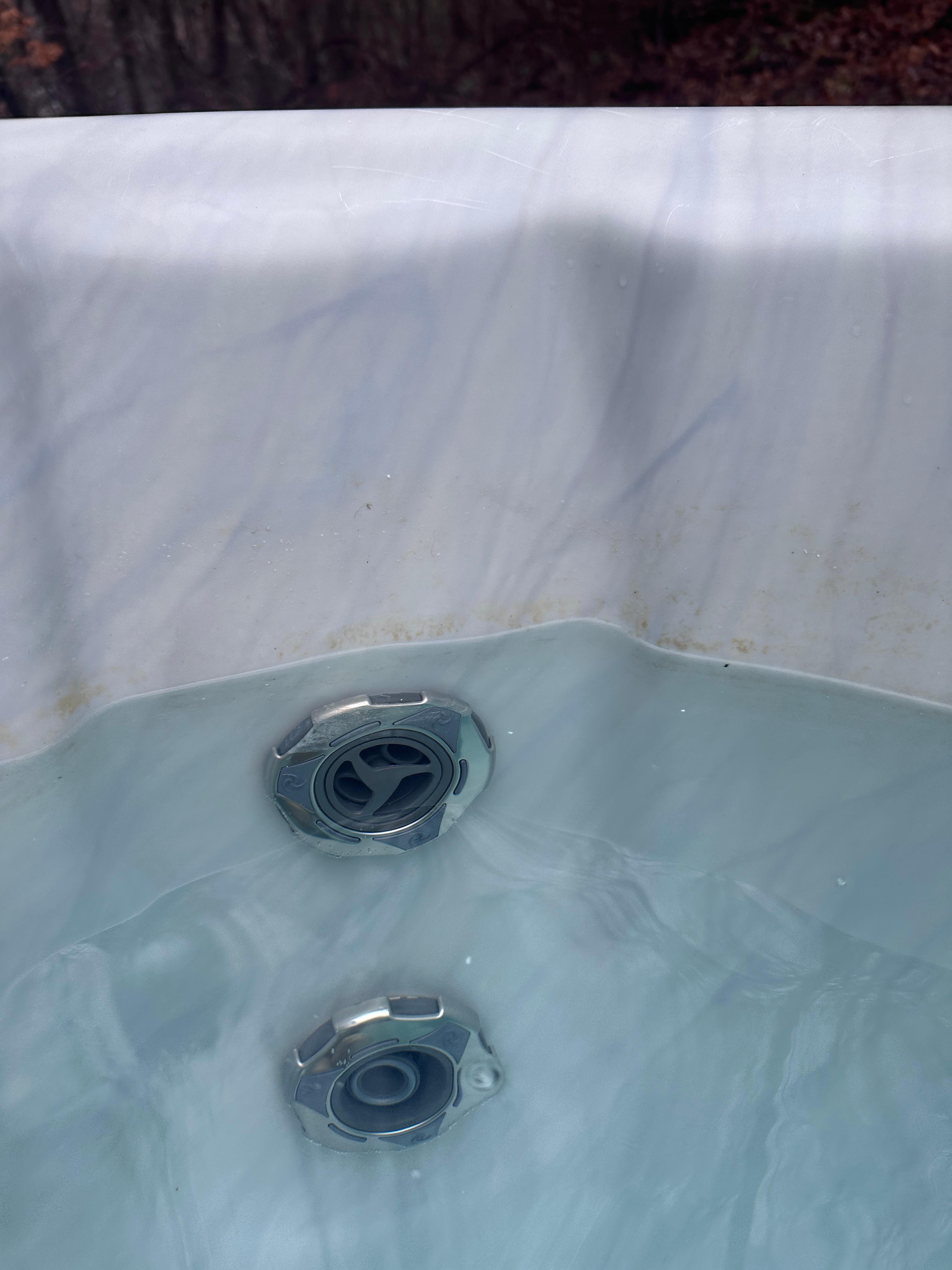 The buildup of scum in the hot tub upon arrival
