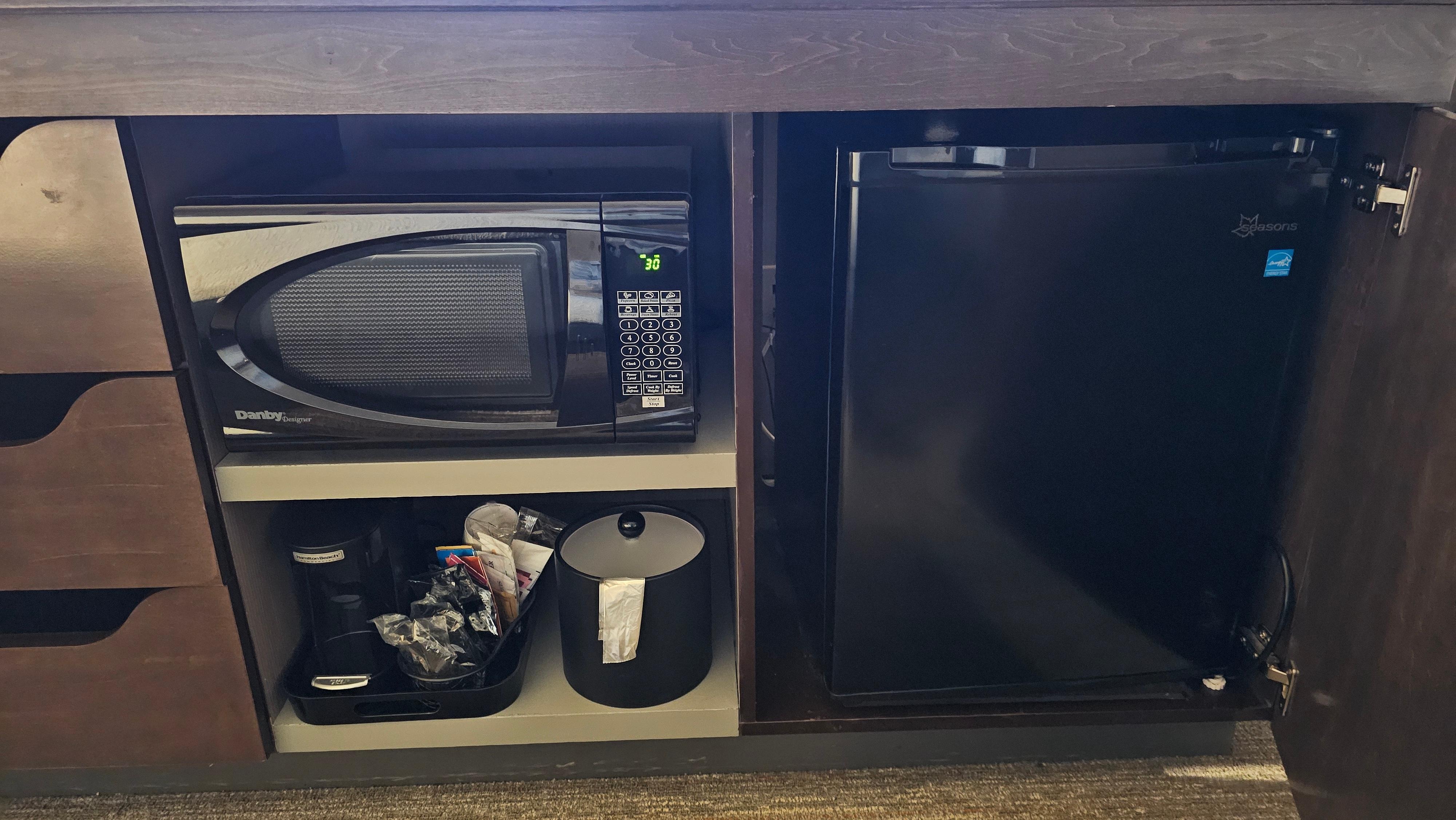 A microwave and refrigerator in the room