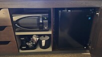 A microwave and refrigerator in the room