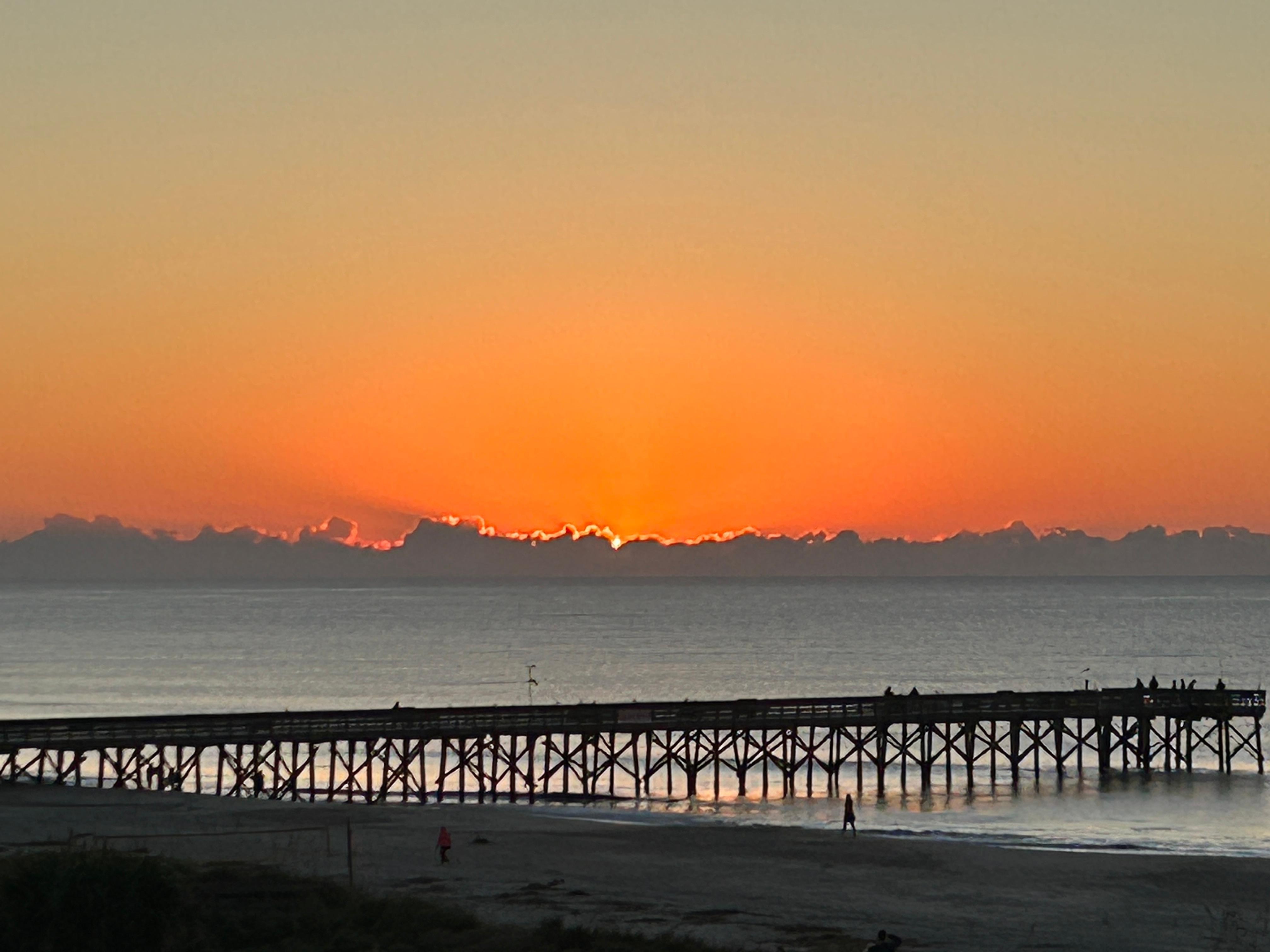 Sunrise behind low-hanging clouds