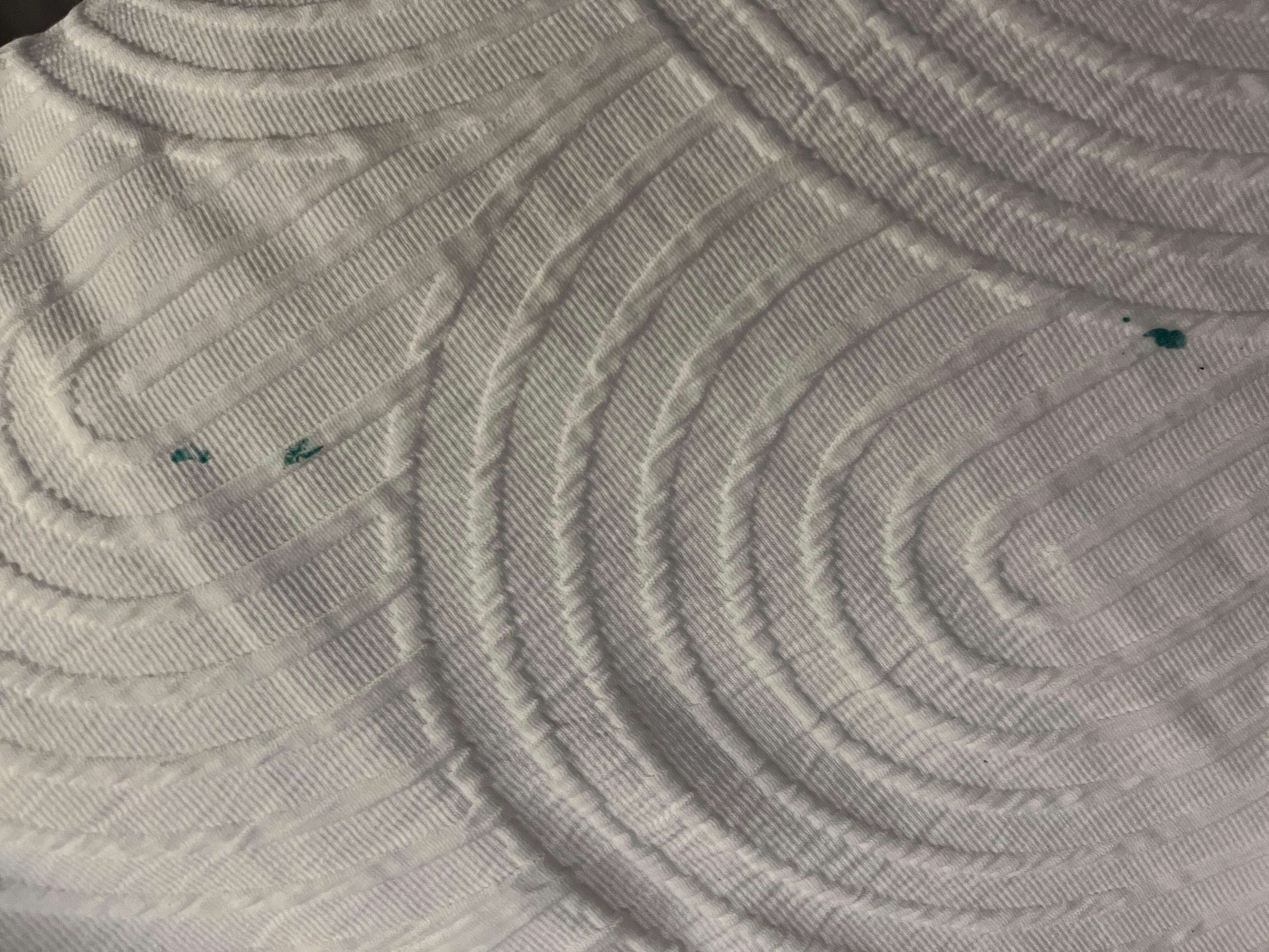 Green paint stain on bedding