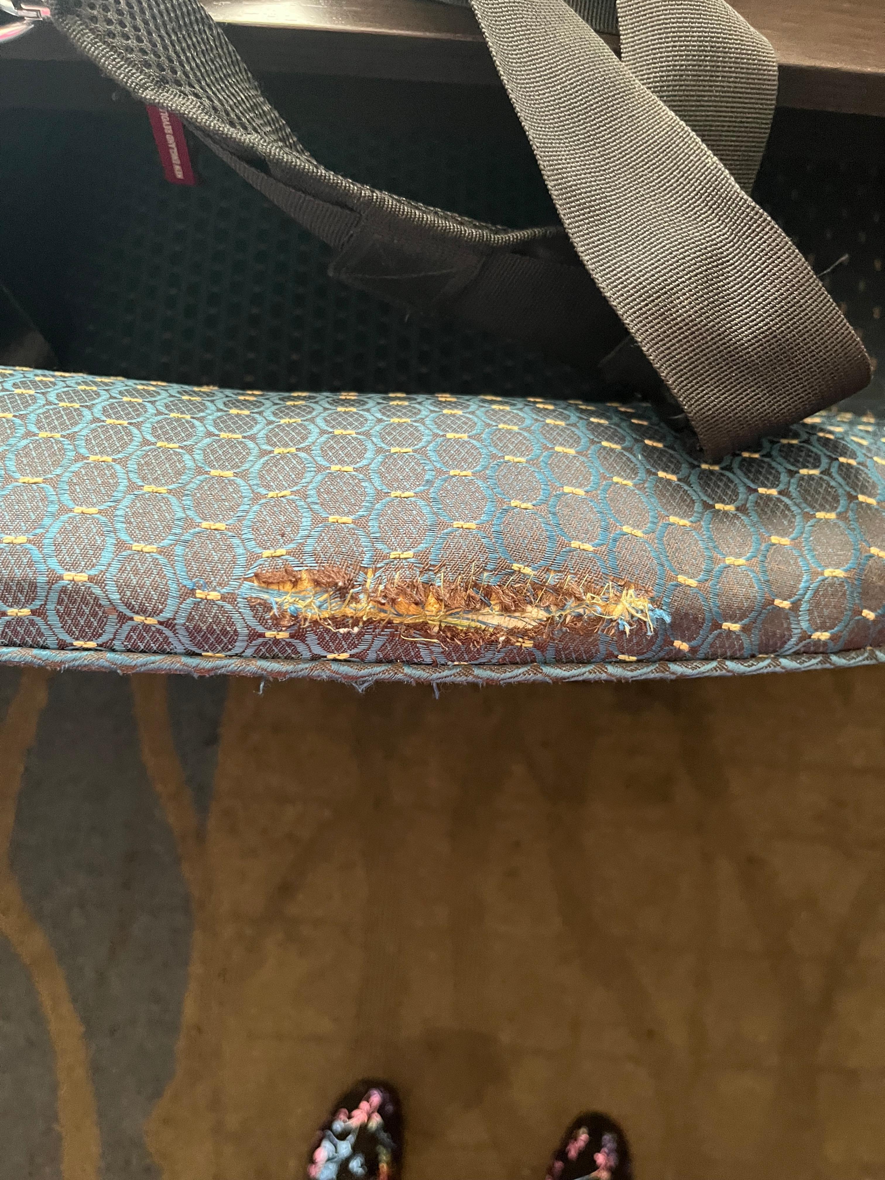 Cigarette burns on ripped chair