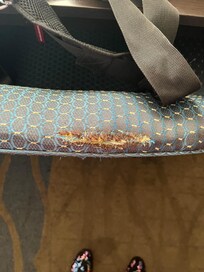 Cigarette burns on ripped chair