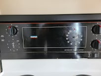Missing knobs on old, run down stove.