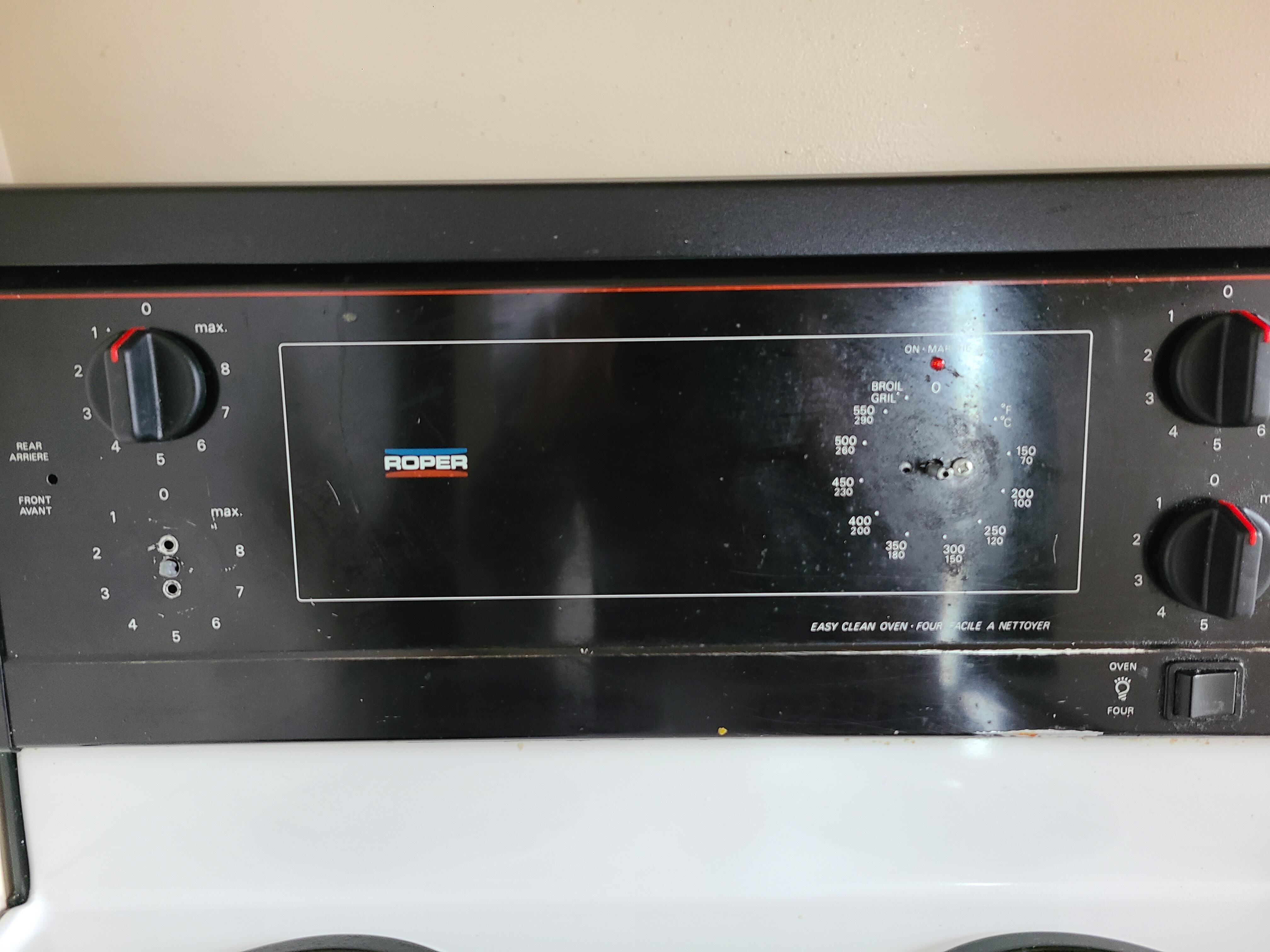 Missing knobs on old, run down stove. 