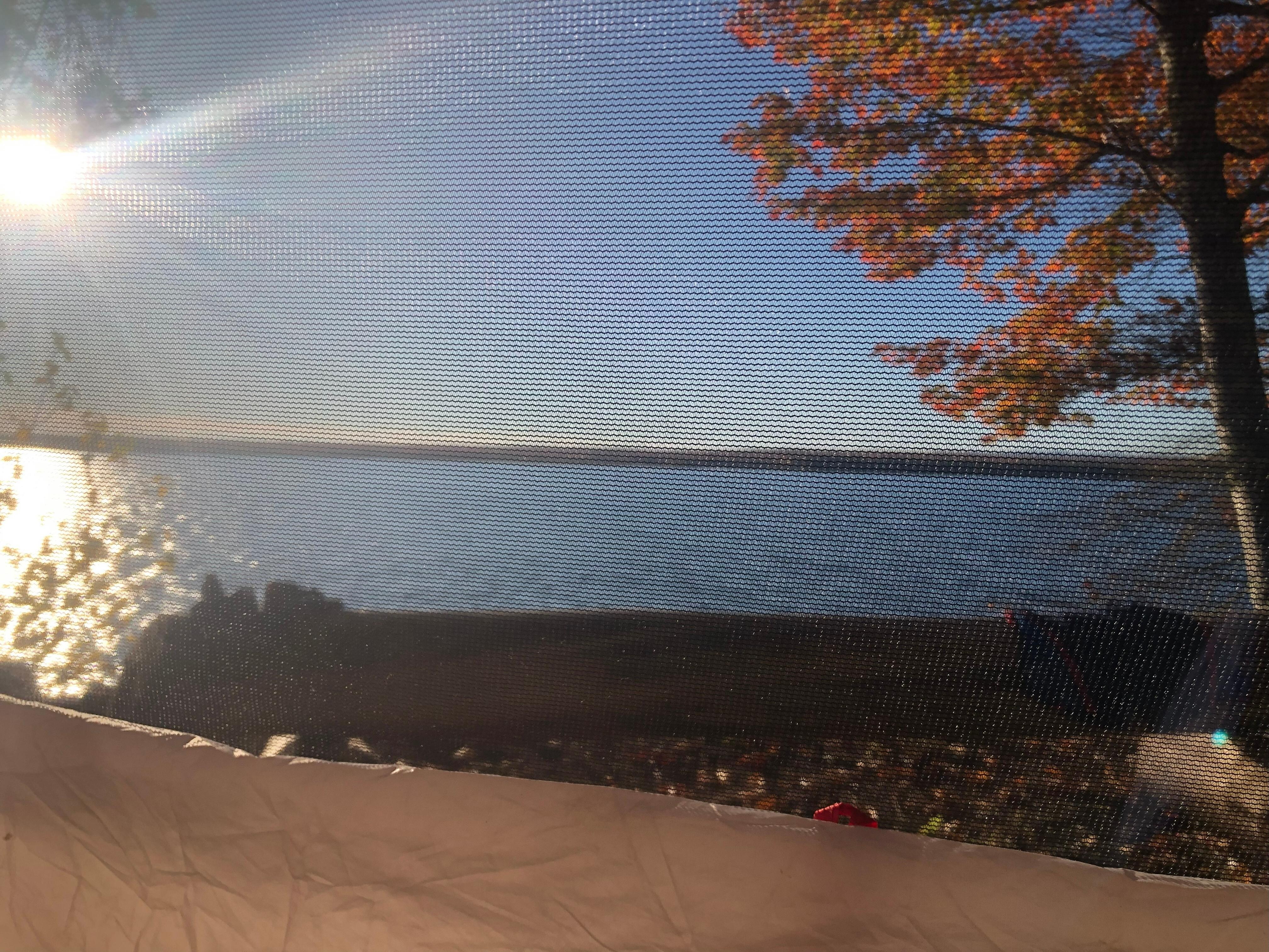 Morning view from my tent on an idyllic Oct morning. Drop-off to shoreline is about 2' in front of that log bench.