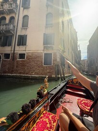 Pointing to the apartment window during our gondola ride